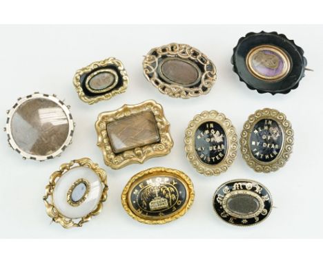 Collection of mostly 19th century mourning brooches, to include black enamelled yellow and white metal brooches; a jet brooch