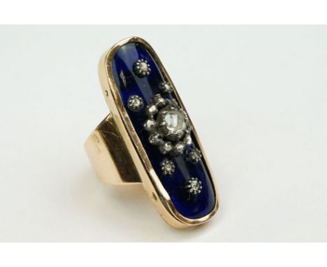 Diamond enamelled unmarked gold and silver set ring, the oval blue enamelled head set with central rose cut diamond, dimensio