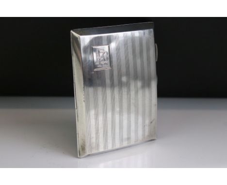 George V silver cigarette case of curved rectangular form, with engine turned striped decoration, gilt interior, monogram to 
