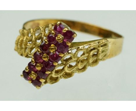 Ruby 18ct yellow gold ring, total of ten small round mixed cut rubies set in two rows, shared prong setting, stylised roped t