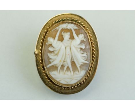 Shell cameo 9ct yellow gold brooch, the oval cameo depicting the Three Graces, rubover set with millegrain detailing, rope tw