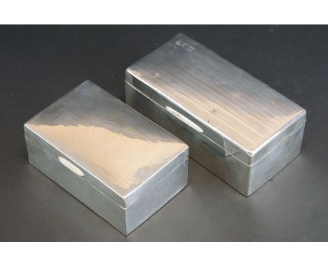 Two silver rectangular cigarette boxes with engine turned decoration, hinged lids, twin-compartment interiors, one with vacan