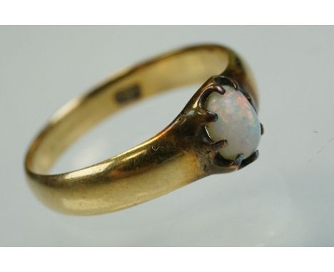 Early 20th century opal 18ct yellow gold ring, the oval cabochon cut precious white opal displaying blue, green, yellow, oran