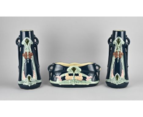 Three-piece Art Nouveau majolica vase set with floral decor. Numbered. 20th century. Size: 29 - 31 cm. In good condition.