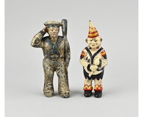 Two old/antique figurative Diecast money boxes. USA 1x Sailor. 1x Clown. First half 20th century. Size: 13 - 14 cm. In good c