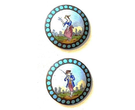 2 Medium size early 20th century hand painted enamel buttons.This pair depicts a man on one and a women on the other. Both ar