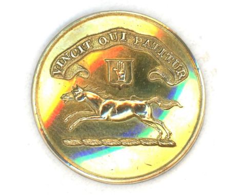 A medium 19th C. brass family crest button with a running horse.This brass crest shows a running horse in fine detail. From t