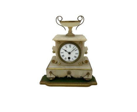 A 19th century French mantle clock in an alabaster case with an 8-day Parisian timepiece movement, case with a flat top surmo