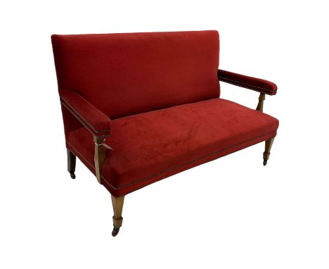 Edwardian walnut framed sofa, upholstered in red fabric with studded detail, square tapering supports with spade feet, brass 