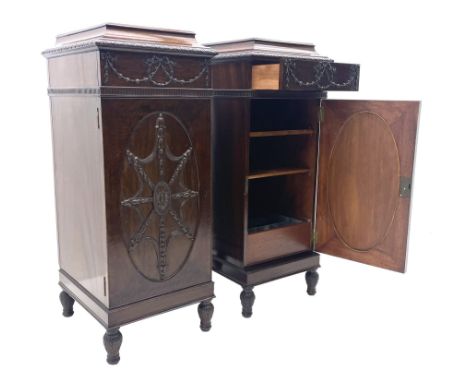 Pair early 20th century Hepplewhite style mahogany pedestal cabinets, cavetto moulded top with foliate carved edge over secre