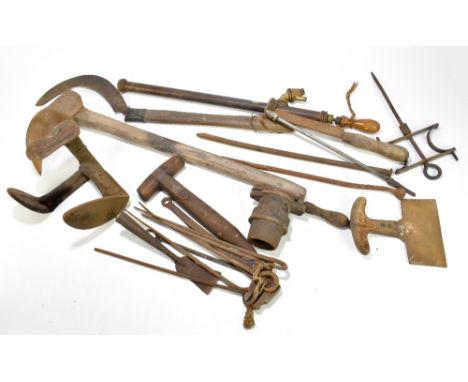 A quantity of tools to include a sickle and a hoe.