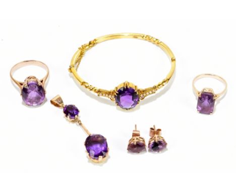 A late Victorian yellow metal snap bangle set with a central amethyst flanked by five seed pearls, with a suite of yellow met