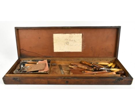 A 19th century oak gun case, the interior lacking dividers and with traces of a paper label, now enclosing various carpentry 