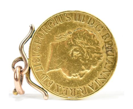 A George III gold sovereign, 1817, with later yellow metal mount.Additional InformationLight wear to the coin, it has been la