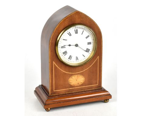 An Edwardian inlaid mahogany lancet top mantel clock, the enamelled dial set with Roman numerals, on four ball feet.