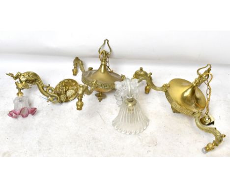 A pair of gilt metal ceiling lights, modelled with three dolphins supporting the shades, width 48cm, a gilt metal wall light 