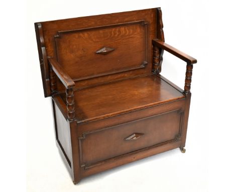 A 1920s oak monk's bench with turned bobbin supports, with fitted brass castors, height 75cm, width 83.5cm.&nbsp;Additional I
