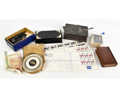 A 19th century base metal inkwell modelled as a book and letter with faux wax seals, length 14cm, with a treen book money box