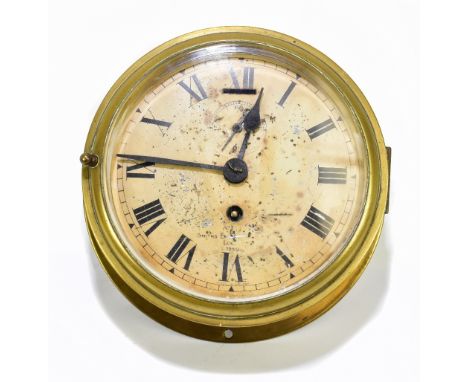 SMITHS OF LONDON; a brass cased ship's clock, the circular dial set with Roman numerals and subsidiary dial, bears stamp date