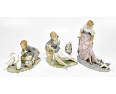 LLADRO; two figure groups comprising a girl feeding geese and a seated girl beside a vase of flowers, also a Nao figure of a 