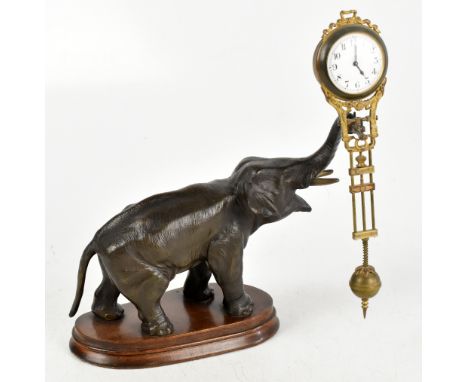 A circa 1900 mystery clock in the form of a bronzed spelter elephant, with trunk turned to the right supporting the gilt meta