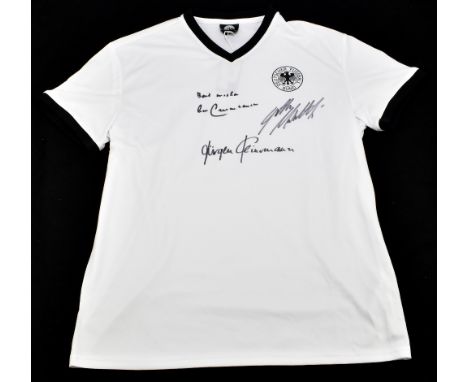 GERMANY; a retro shirt, signed to the front by Beckenbauer, Klinsmann and Matthaus, size L.Additional InformationCreasing and