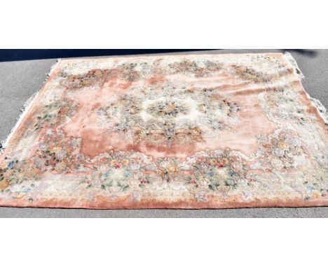 A large Chinese carpet with floral decoration on a salmon pink ground, approx. 390 x 280cmAdditional InformationThis is a woo