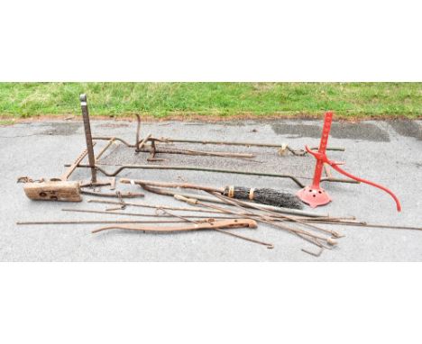 Two vintage cast iron carriage jacks, a WWII stretcher, various other metal tools, etc.