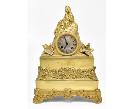 A 19th century French gilt brass mantel clock in the manner of Leroy of Paris, with surmount modelled as a lady holding a boo