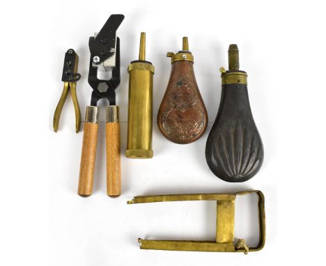 Two embossed shot flasks, a further brass shot flask, and other items.&nbsp;