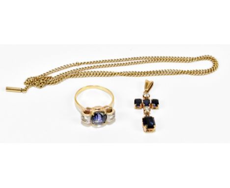 A yellow metal diamond and sapphire three stone dress ring, the central princess cut sapphire flanked by two princess cut dia