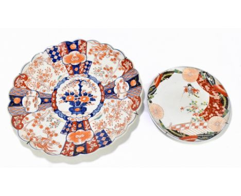 A 19th century Japanese Imari circular wall charger with scalloped edge, decorated in panels with exotic birds, flowers and l