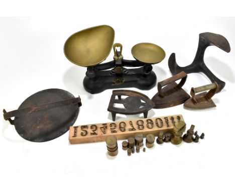A set of iron framed balance scales, a wrought iron boot stretcher, and assorted metalware.