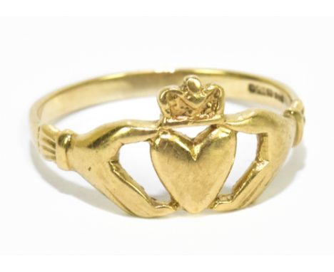 A 9ct yellow gold ring centred with two hands clasping a heart, ring size P 1/2, approx. 2g.