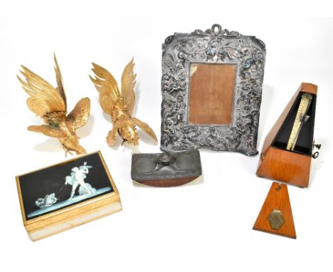 A small group of collectors' items including a metronome, embossed silver plated mirror, pair of fighting cockerels, blotter 