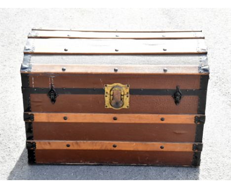 A vintage wooden bound canvas dome top travelling trunk.