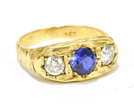 A gentleman's 18ct textured gold three stone dress ring set with a central sapphire flanked by two diamonds, diamonds approx 