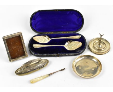 A mixed group of hallmarked silver items including a cased pair of spoons, a nail buffer, a picture frame, a ring stand, a di