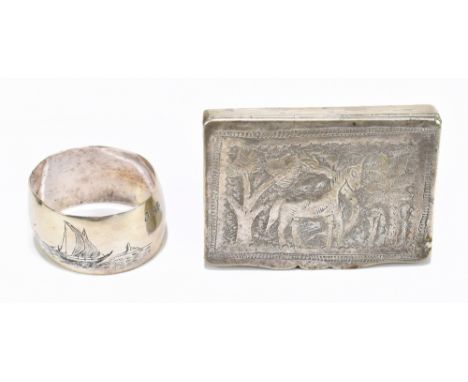 An Indian white metal snuff box of rectangular form, embossed and chased with giraffes in landscape, and a white metal napkin