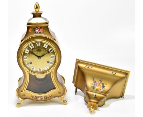A modern Italian style bracket clock with bracket, with floral decoration to the gilded case and applied Roman numerals, the 