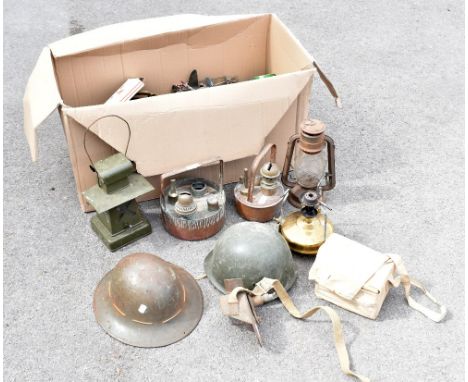 An assortment of military items including an ARP-type helmet, a later American composite helmet, a green signal lamp, other l