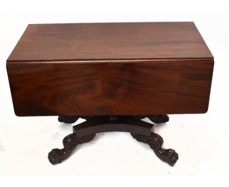 A William IV mahogany Pembroke table with drawer, on a turned column platform and scroll legs with carved paw feet, height 73