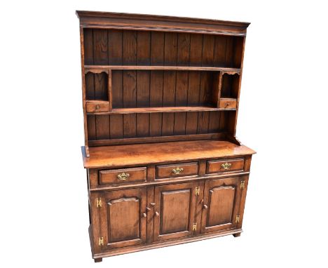 TITCHMARSH &amp; GOODWIN; a reproduction oak dresser, the boarded plate rack with two fixed shelves and two spice drawers abo