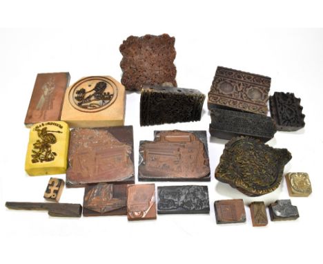 A collection of assorted printing presses and copper printing plates.