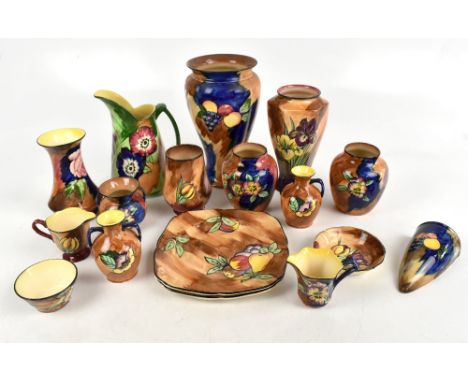 H &amp; K TUNSTALL; a collection of sixteen ceramic vessels and plates decorated with flowers and fruit, the tallest 26cm.&nb