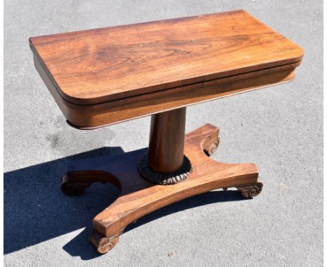 A Victorian rosewood fold over card table, raised on single column support, height 74cm, width 91cm, depth 46cm.