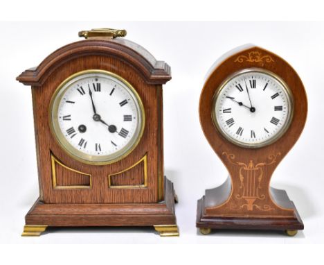 An Edwardian inlaid mahogany balloon shaped timepiece, the enamelled dial set with Roman numerals on four brass feet, height 