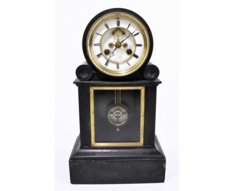 A Victorian slate mantel clock, the drum face set with enamelled chapter ring bearing Roman numerals above a glazed front, he