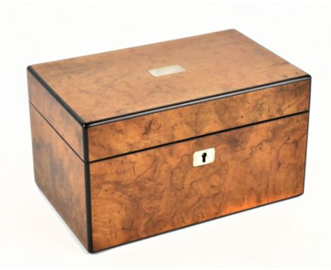 A 19th century walnut tea caddy of rectangular form, the hinged cover with applied mother of pearl cartouche and escutcheon, 