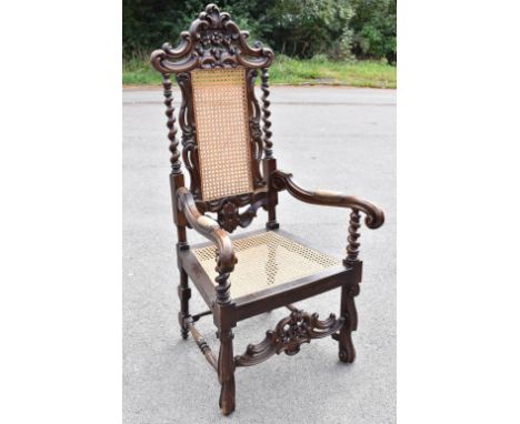 A late 19th century Continental stained beech armchair of 17th century design, with caned back and seat, on scroll legs, heig